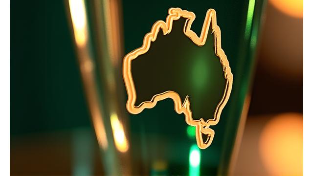A polished trophy on a pedestal, with a subtle Australian map outline in the background, signifying an agency award.
